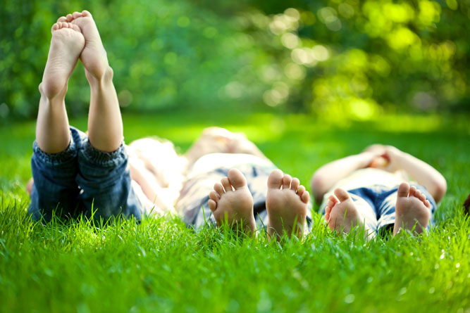 children laying in the grass