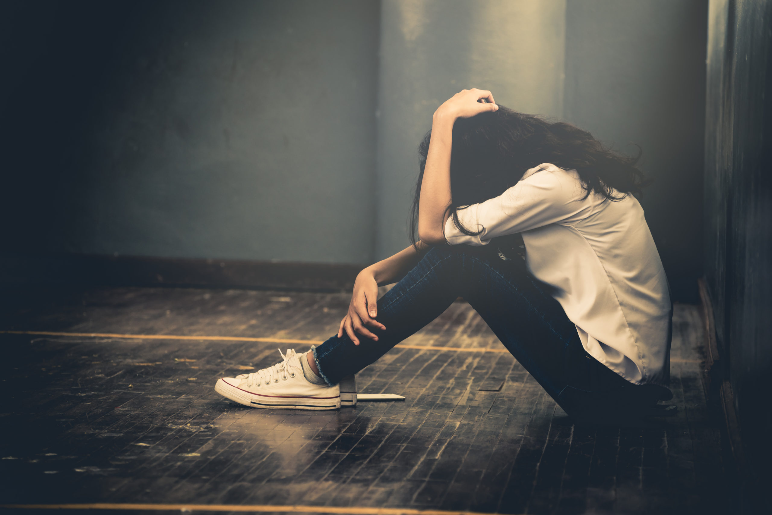 girl sitting down struggling with crack cocaine abuse