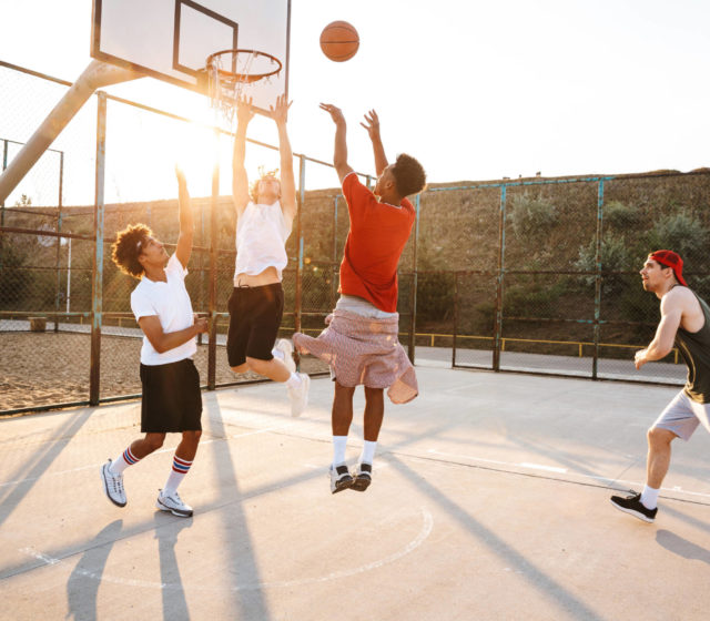 young men playing basketball